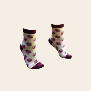 Pair of pink and magenta coloured socks shown on feet.