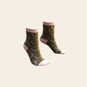 Pair of olive green and pink socks shown on feet.
