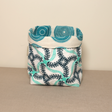 A fabric pot with a sea creature pattern in shades of blue and white, handmade from organic cotton.