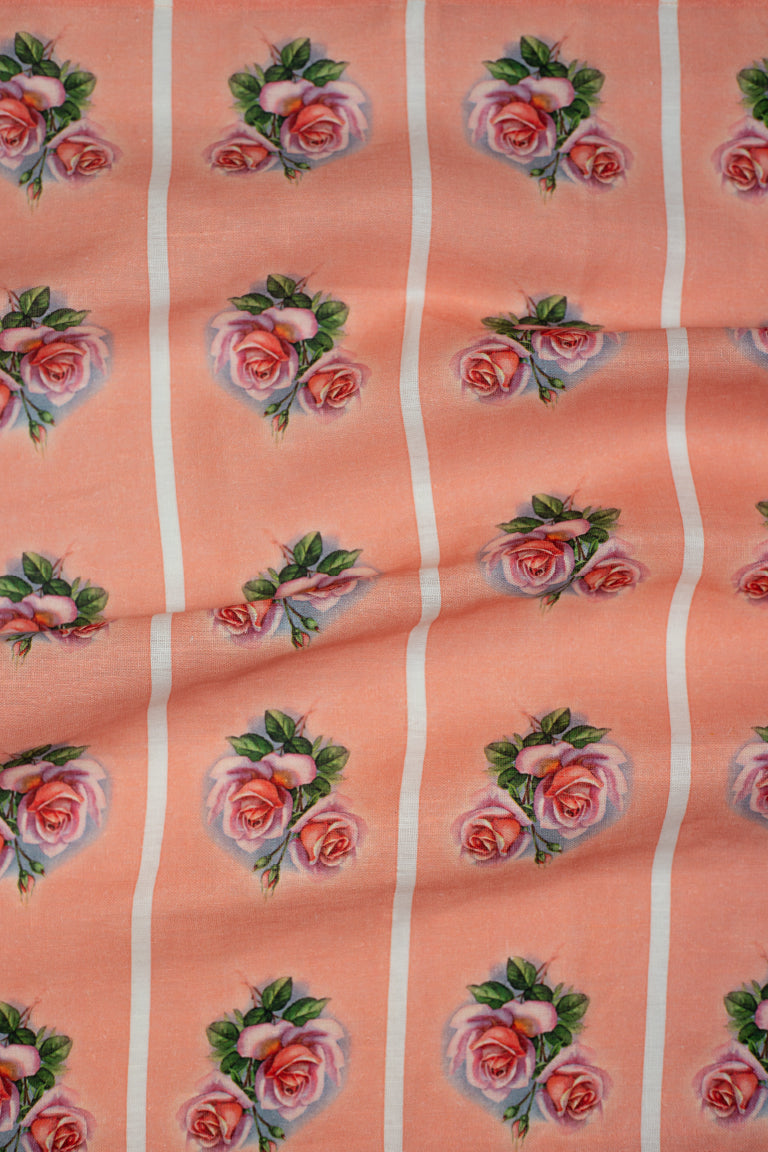 A vintage style pink linen tea towel with a pink and green rose motif repeated vertically in four stripes down the tea towel.