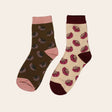 Flatlay of two pairs of socks with pohutukawa flower on them sitting side by side. 